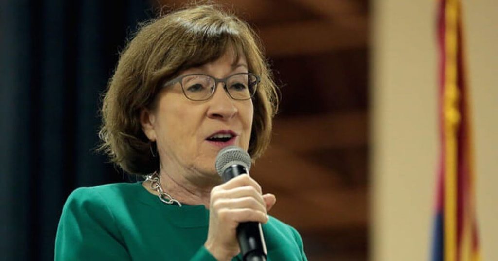 Susan collins holding a microphone