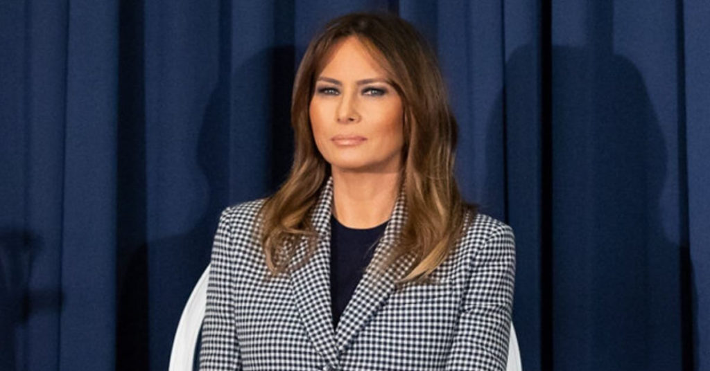 Melania sitting in a chair