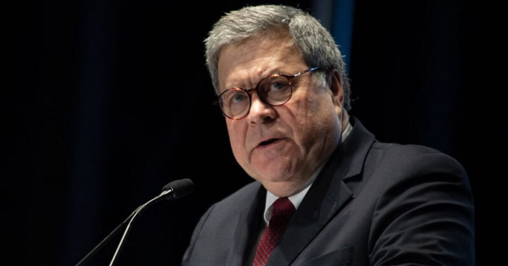 Barr standing at a podium