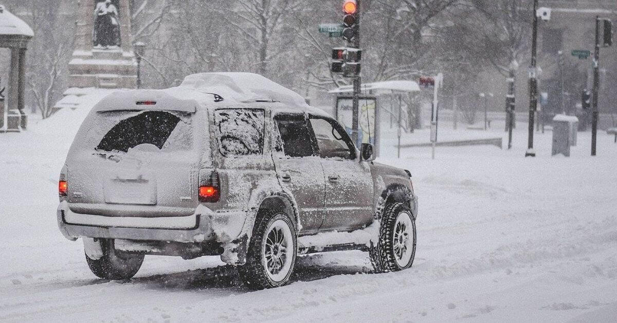 A vehicle driving on a snowy street