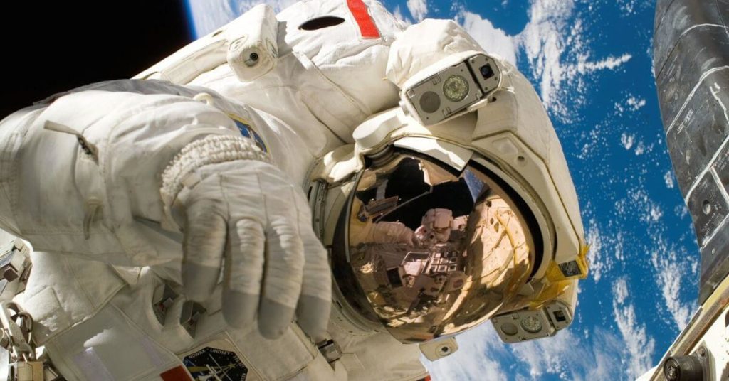 An astronaut floating in space with Earth in the background
