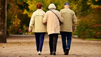Three elderly people taking a walk