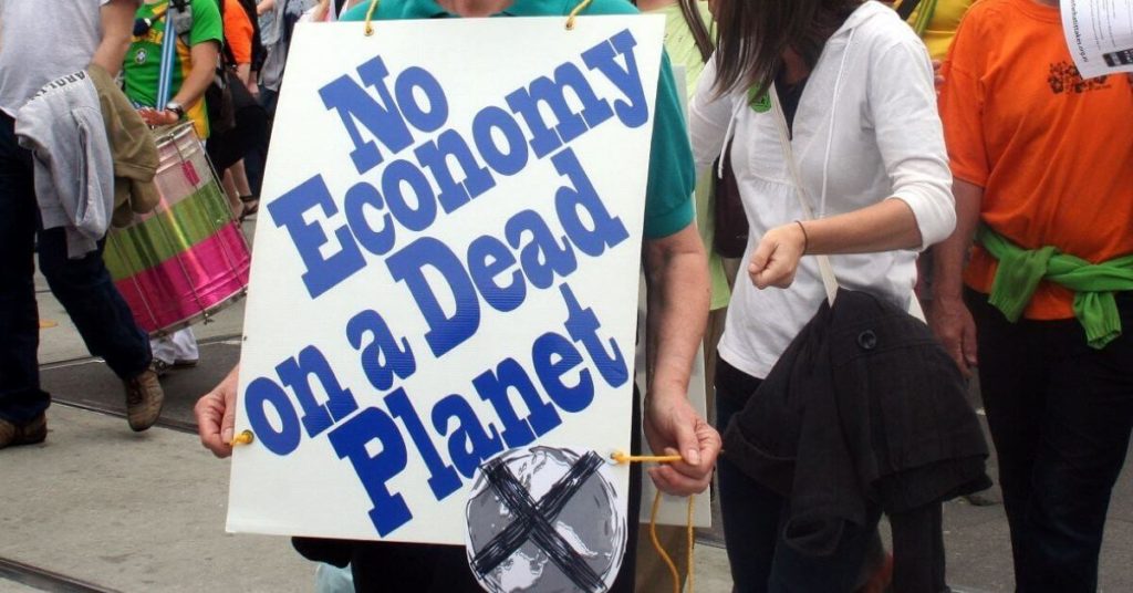 Climate protestors holding signs
