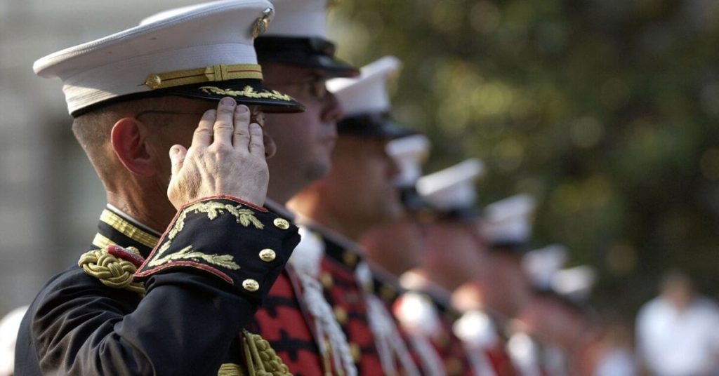 A photograph of a row of men in military dress uniforms.