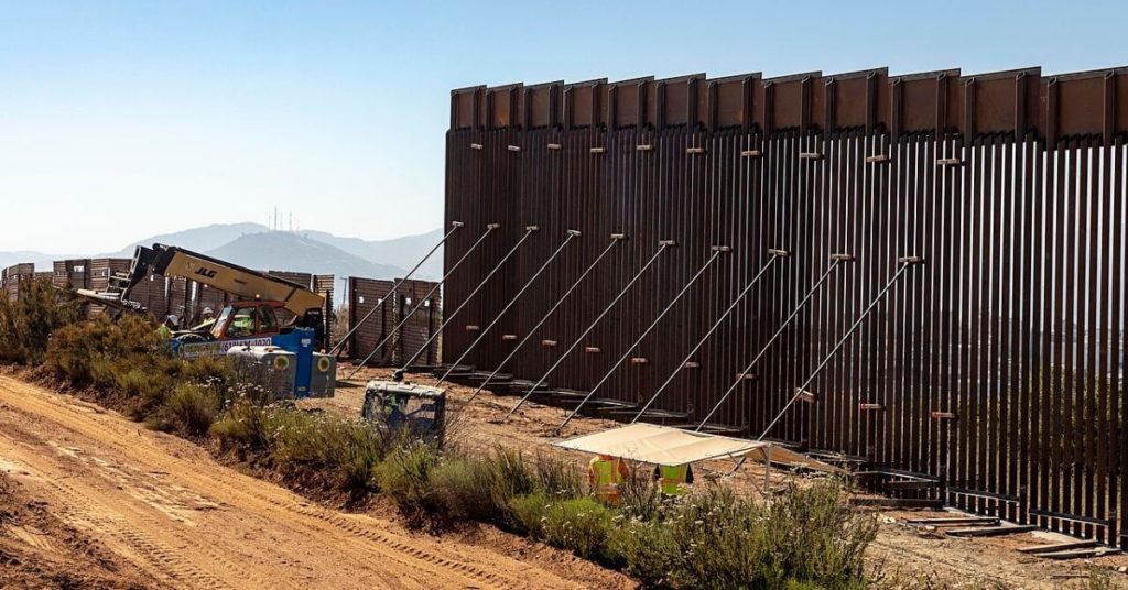 A photograph of construction of a wall along the southern border of the U.S.