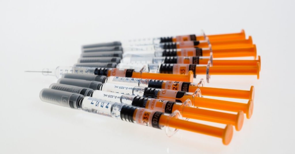 Several vaccines lined up on a white background