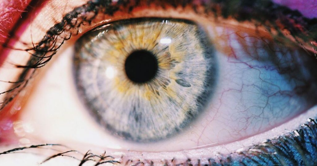 A close up photograph of a blue eye