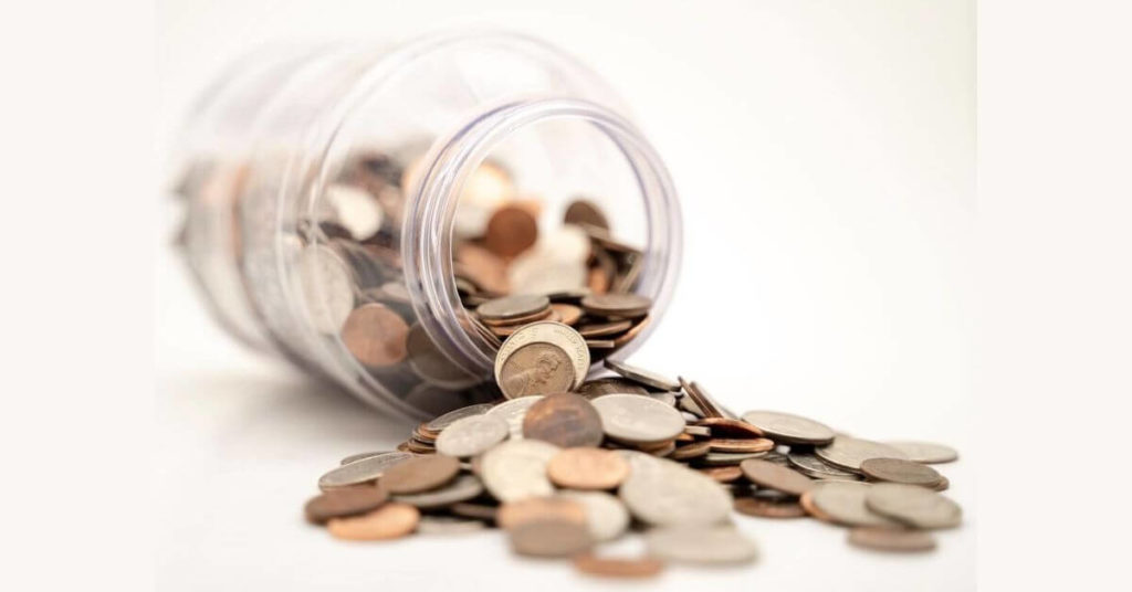 Coins spill from a jar.