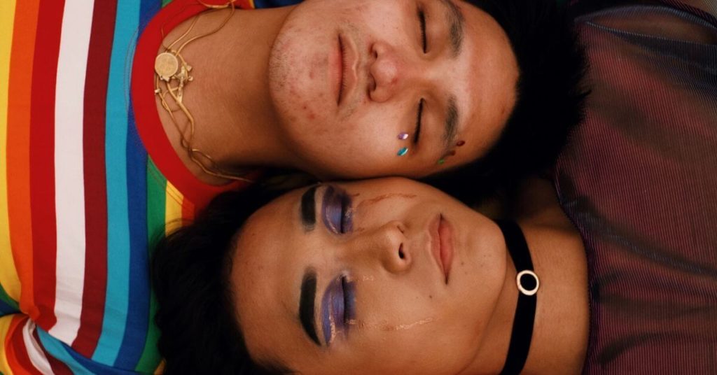 LGBTQ+ couple lying side by side