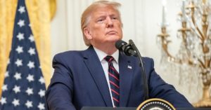 President Trump standing behind a podium
