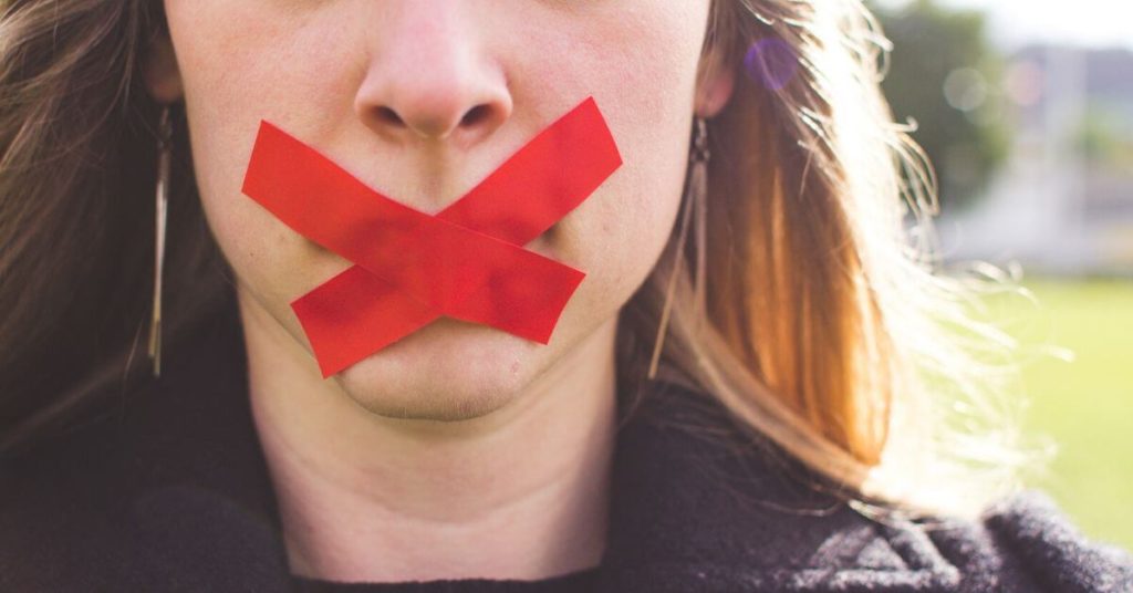 Woman with tape over her mouth