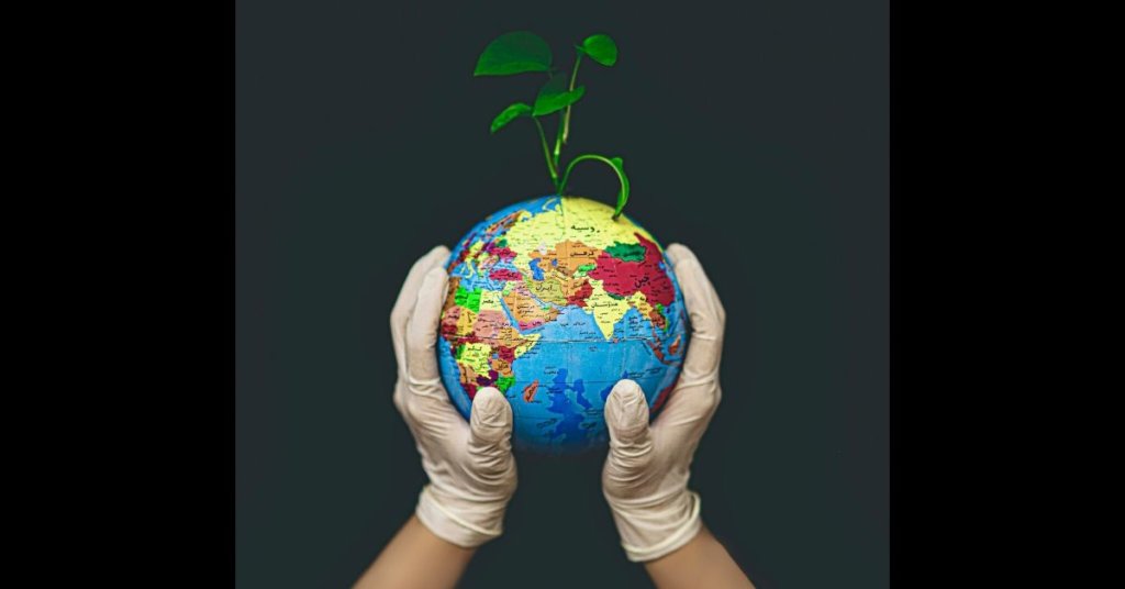 hand with glove holding globe