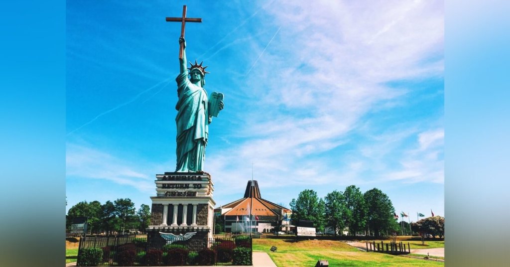 A doctored photograph shows the Statue of Liberty holding a cross rather than a torch.