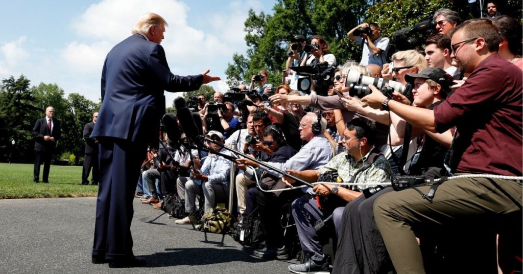 Trump standing in front of a group of reporters