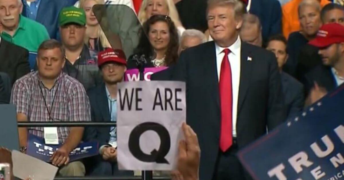 Photo of Qanon followers with Trump at a rally.