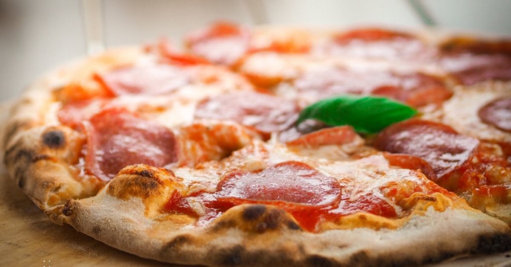 Close up of a pizza cut into slices