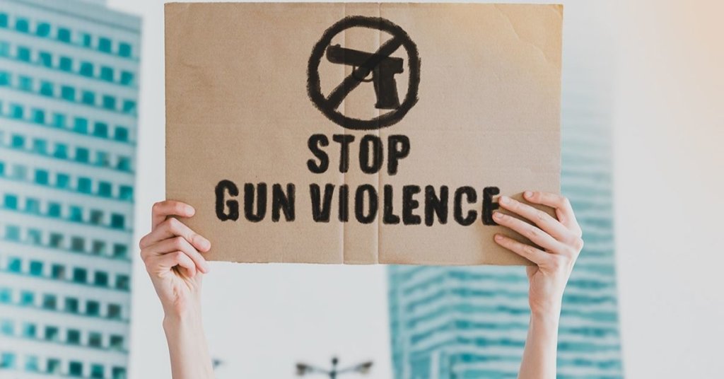 Person holding a stop gun violence sign