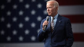 Biden standing with a microphone