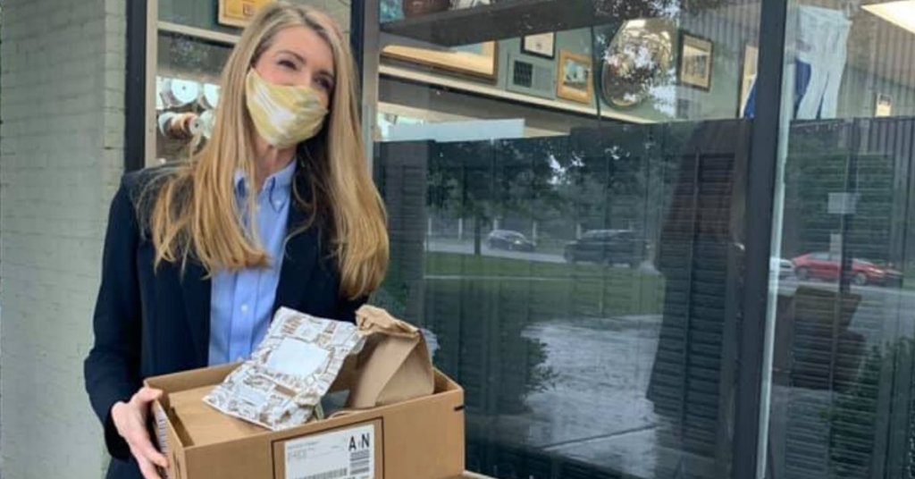 Sen. Kelly Loeffler holding a box