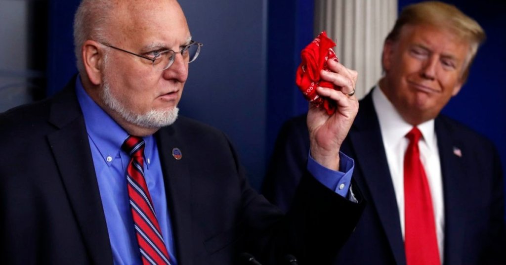 Dr Redfield holding a red bandana while President Trump looks on