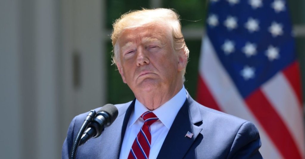 Trump standing in front of a microphone