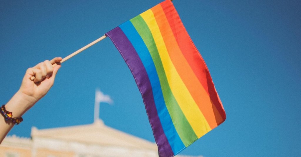A person holding a pride flag