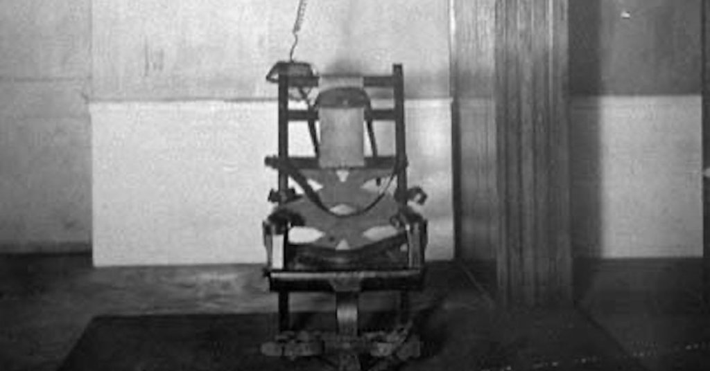 A grainy photograph of the first electric chair