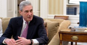 A photo graph of Robert Mueller in conversation in the Oval Office.