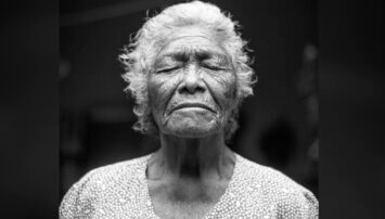 Elderly woman with her eyes closed