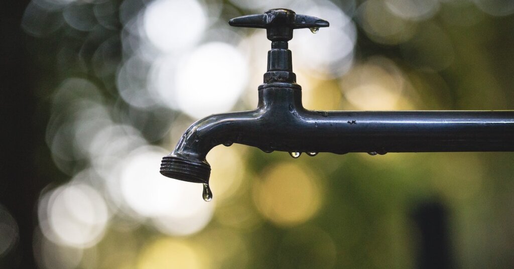 Water drips from a tap.