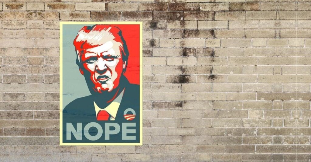 Poster of Trump on a brick wall that says nope