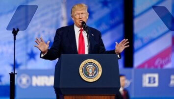 Trump standing behind a podium