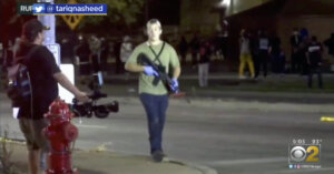 Kyle Rittenhouse walks through the streets of Kenosha proudly carrying an automatic rifle.