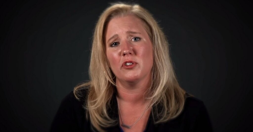 Elizabeth Neumann in front of a black background