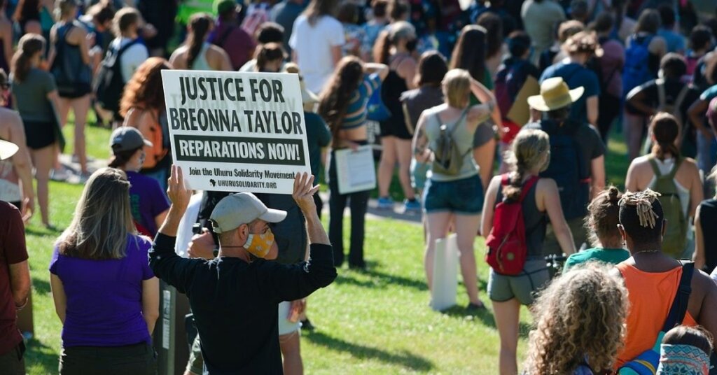 Demonstrator holding a sign in support of Breonna Taylor