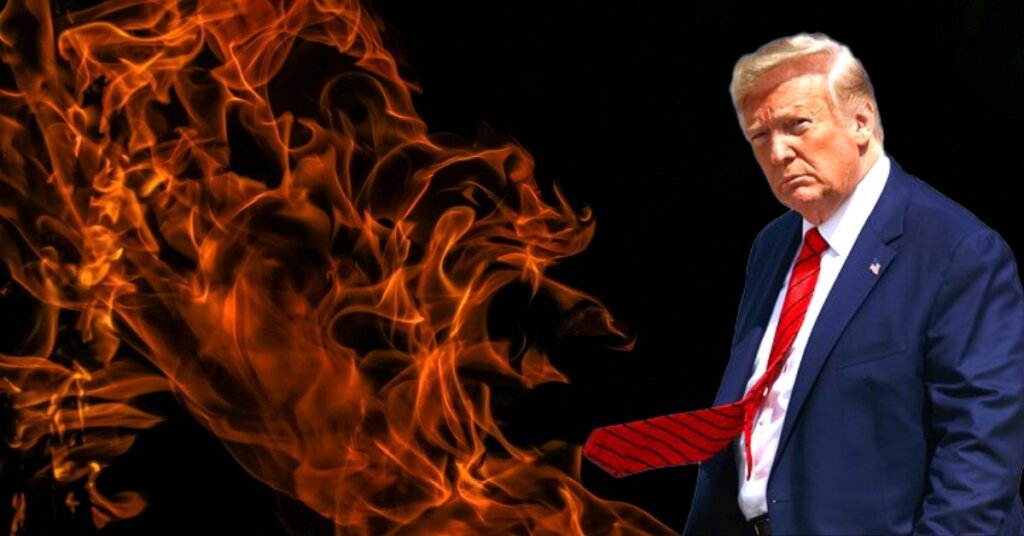Trump standing in front of a fiery background