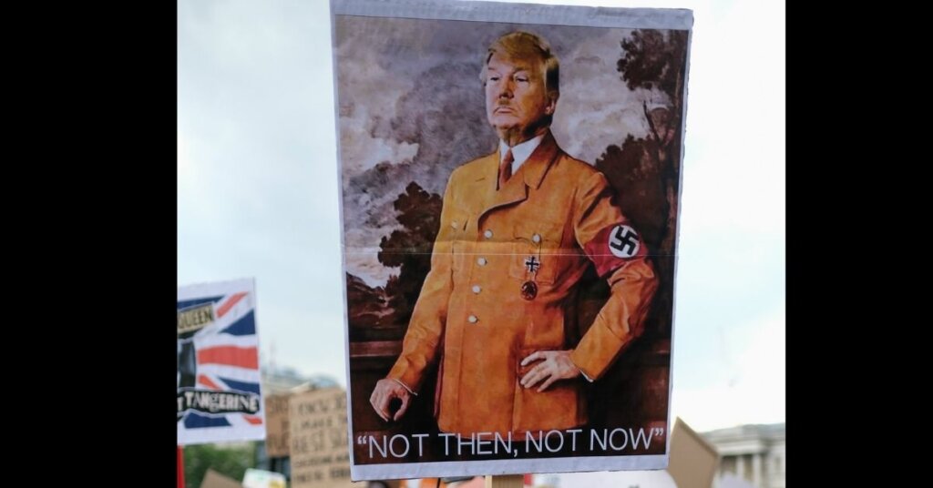 A sign with Trump dressed as Hitler