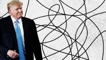 Trump holding a Sharpie standing in front of a scribbled background