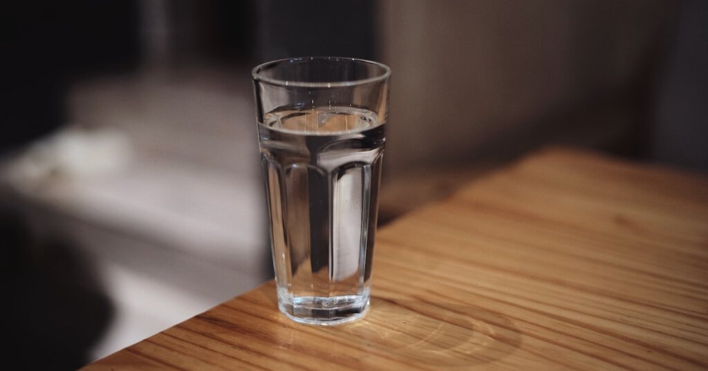 A glass of clean water sits on a table.