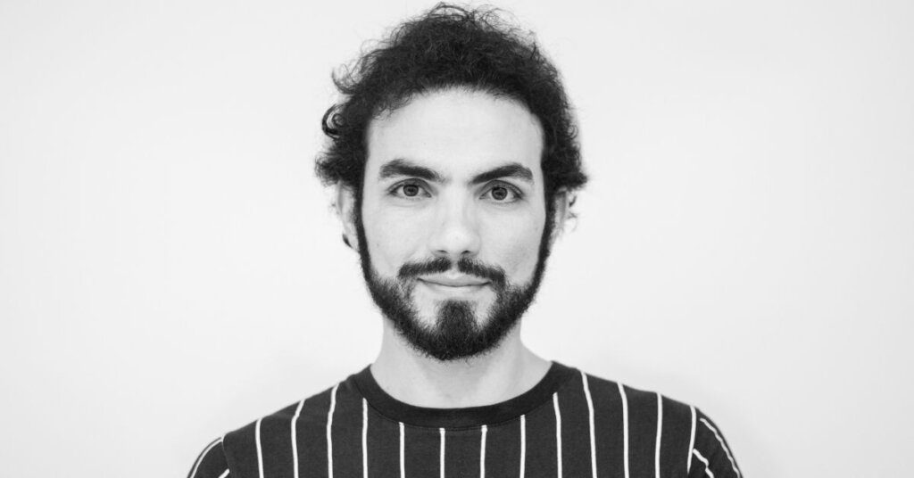 Medium shot of a man wearing a striped shirt