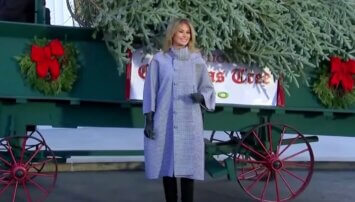 Melania standing in front of the christmas tree delivery