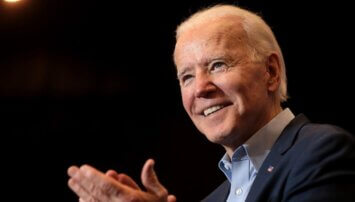Biden smiling and gesturing to crowd