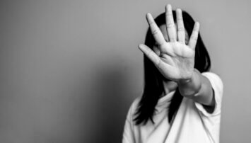 Black and white photo of a woman holding out her hand