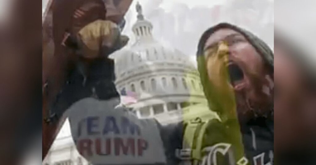 A member of Trump's insurrection screams in front of the US Capitol.