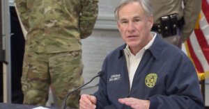 Texas governor speaking into a microphone