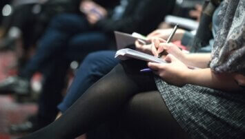 Photo of reporters taking notes