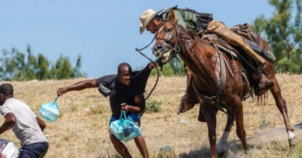 Border Patrol agent on horseback threatens Haitian asylum seeker